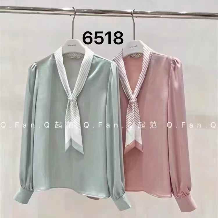 light blue tie-neck blouse. chic tie-neck and long, slightly puffed sleeves.
