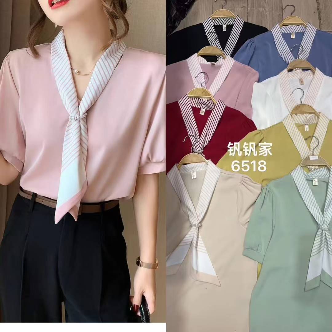 light blue tie-neck blouse. chic tie-neck and long, slightly puffed sleeves.
