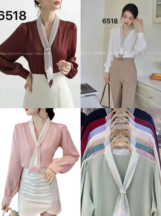 light blue tie-neck blouse. chic tie-neck and long, slightly puffed sleeves.