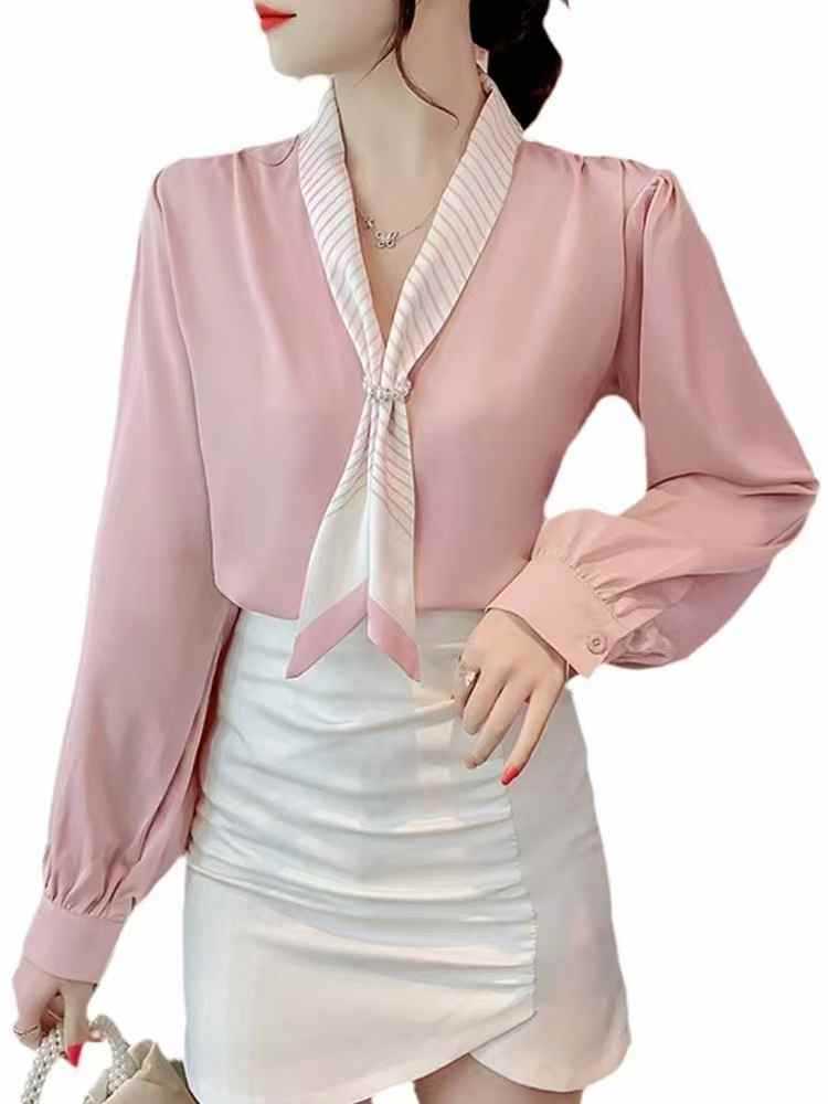 light blue tie-neck blouse. chic tie-neck and long, slightly puffed sleeves.