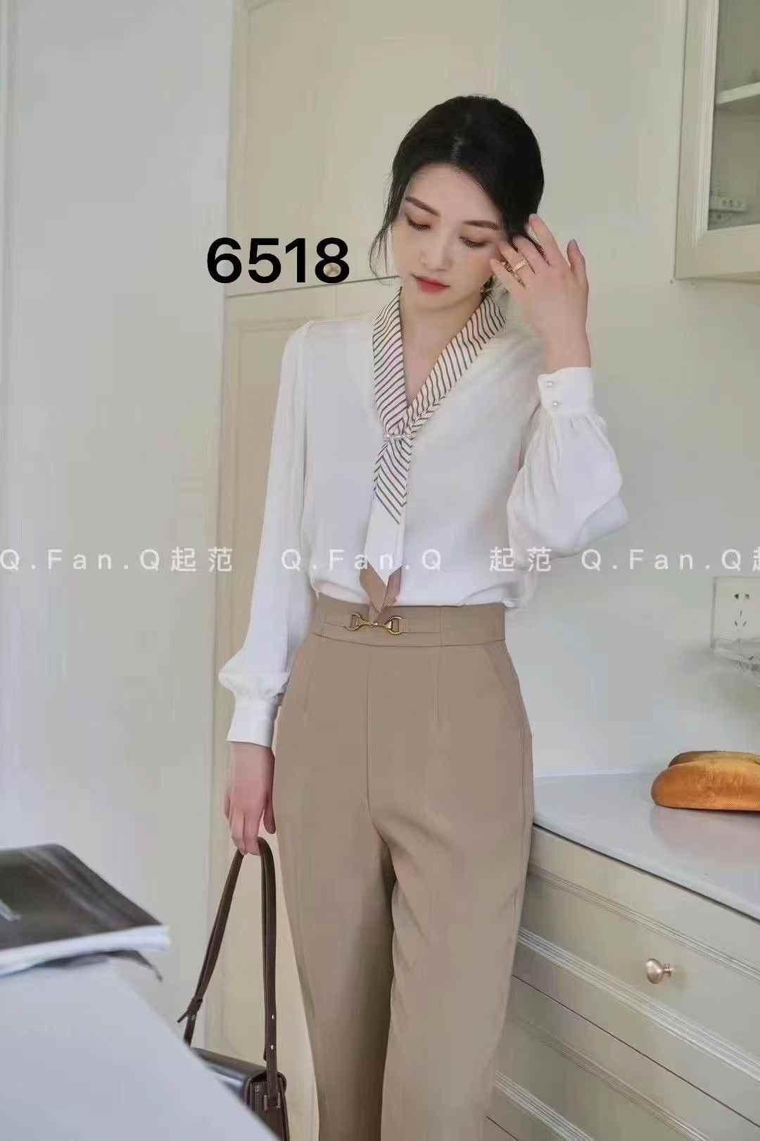 light blue tie-neck blouse. chic tie-neck and long, slightly puffed sleeves.