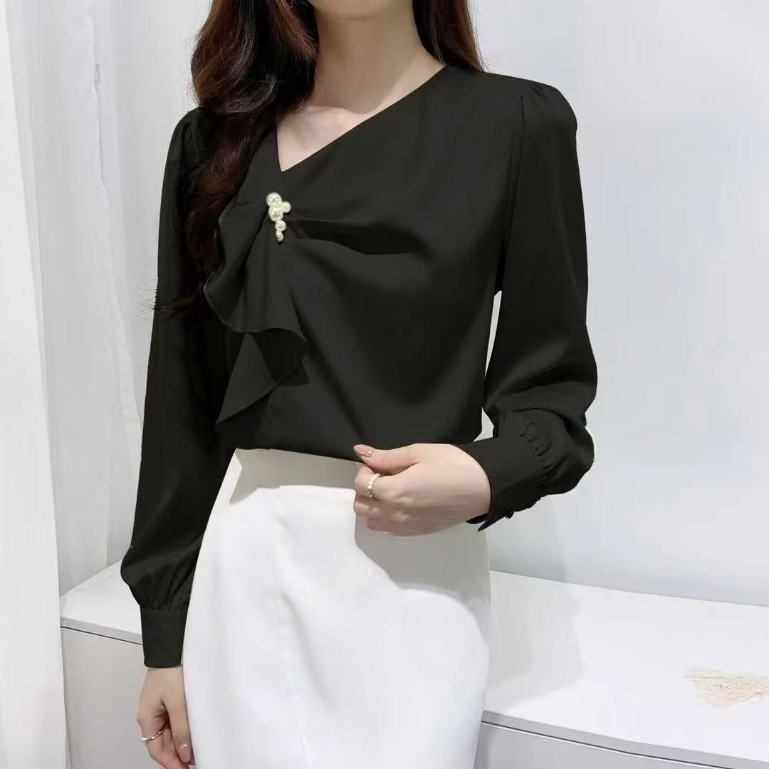 ruffled blouse with pearl.blouse has long sleeves and gathered accents on the chest, along with a pearl embellishment near the neckline.
