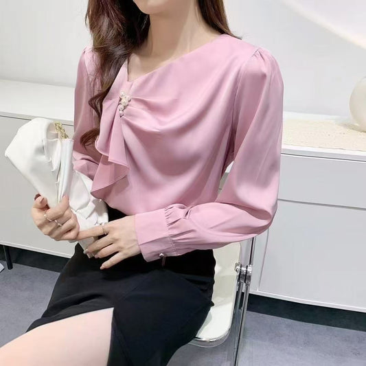 ruffled blouse with pearl.blouse has long sleeves and gathered accents on the chest, along with a pearl embellishment near the neckline.