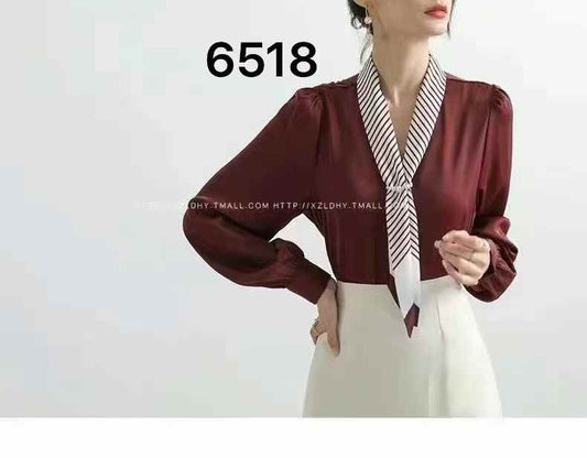 light blue tie-neck blouse. chic tie-neck and long, slightly puffed sleeves.