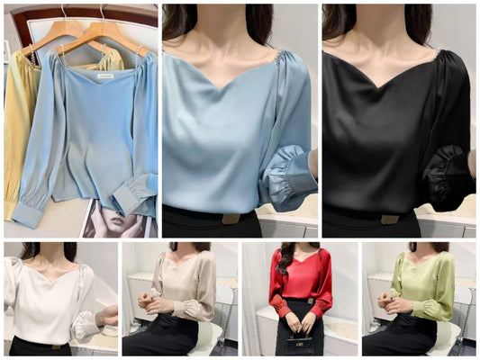 satin blouse, perfect for a vintage or office-casual Korean-inspired look, features a V-neckline with delicate pearl detailing at the shoulders and stylish gathered or ruffled long sleeves.